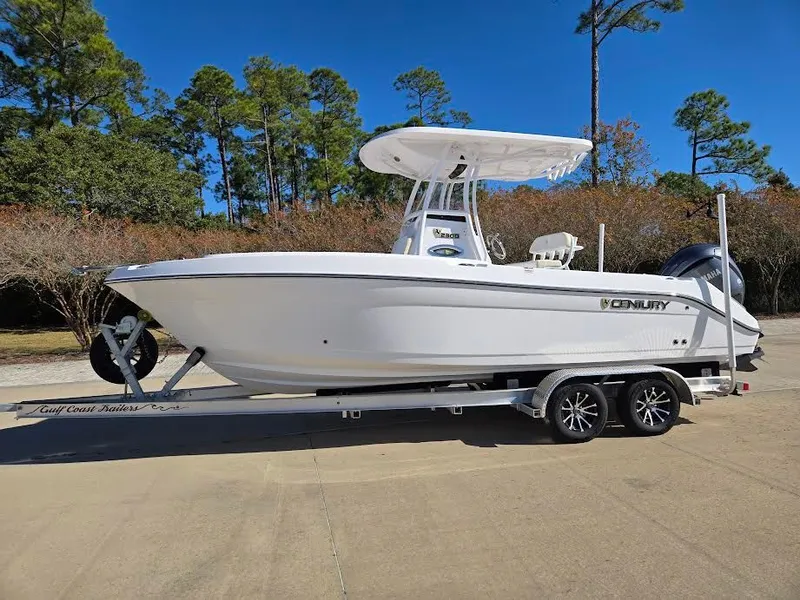 Slide: The Image of 2024 Century 2300 Center Console on trailer, parked outdoors. - 3