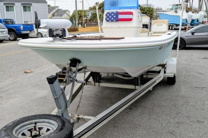 Slide: The Image of 2004 Everglades 180 Center Console boat on trailer, parked in a residential area. - 11