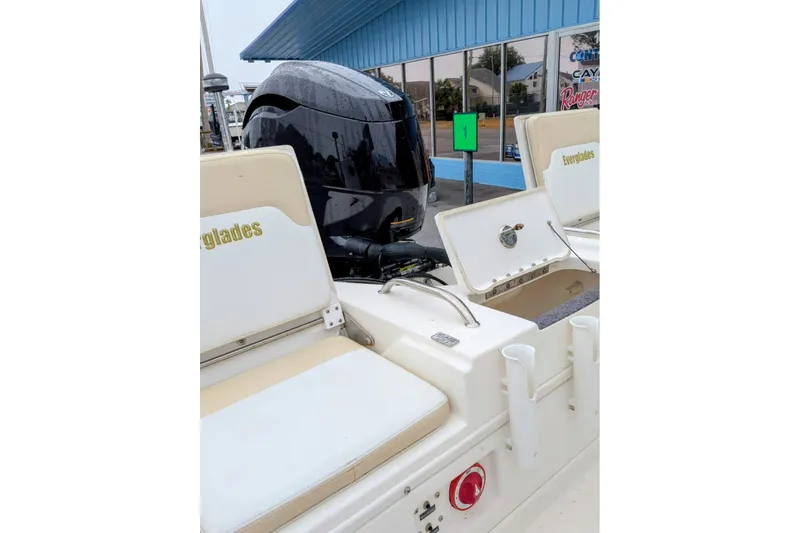 Slide: The Image of 2004 Everglades 180 Center Console boat with open storage compartments and outboard motor. - 12