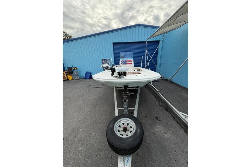 Slide: The Image of 2004 Everglades 180 Center Console boat on trailer near blue building. - 4