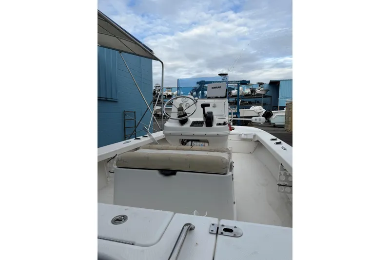 Slide: The Image of 2004 Everglades 180 Center Console boat on trailer, parked near blue building. - 5