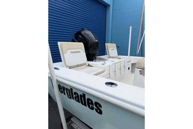 Slide: The Image of 2004 Everglades 180 Center Console boat with Yamaha engine, docked near blue building. - 7