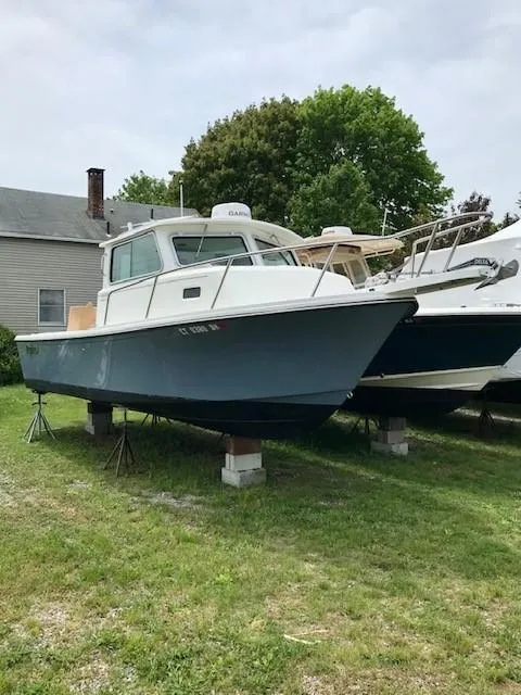 Slide: The Image of 2017 Parker 2520 XL Sport Cabin boat elevated outdoors. - 1