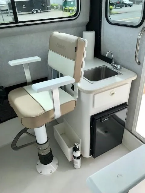 Slide: The Image of Interior of Parker 2520 XL Sport Cabin boat, featuring seat and sink. - 10