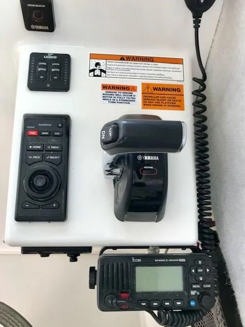 Slide: The Image of Yamaha controls and Icom radio in Parker 2520 XL Sport Cabin. - 13