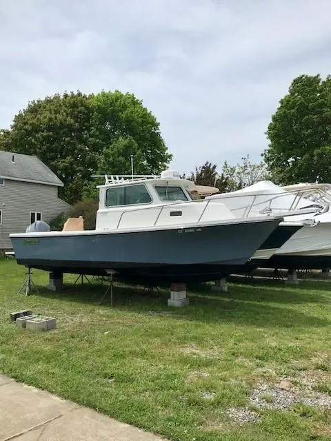 Slide: The Image of 2017 Parker 2520 XL Sport Cabin boat elevated outdoors. - 2