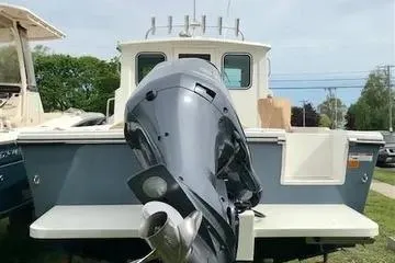 Slide: The Image of 2017 Parker 2520 XL Sport Cabin boat with outboard motor, docked outdoors. - 24