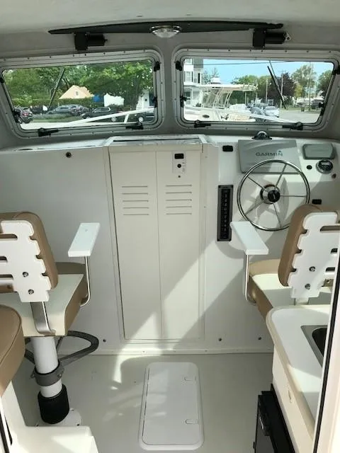 Slide: The Image of 2017 Parker 2520 XL Sport Cabin interior with helm and seating. - 8