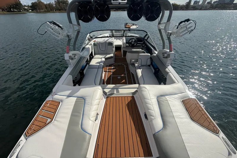Slide: The Image of 2013 Nautique Super Air Nautique G23 Coastal Edition boat interior on water. - 4