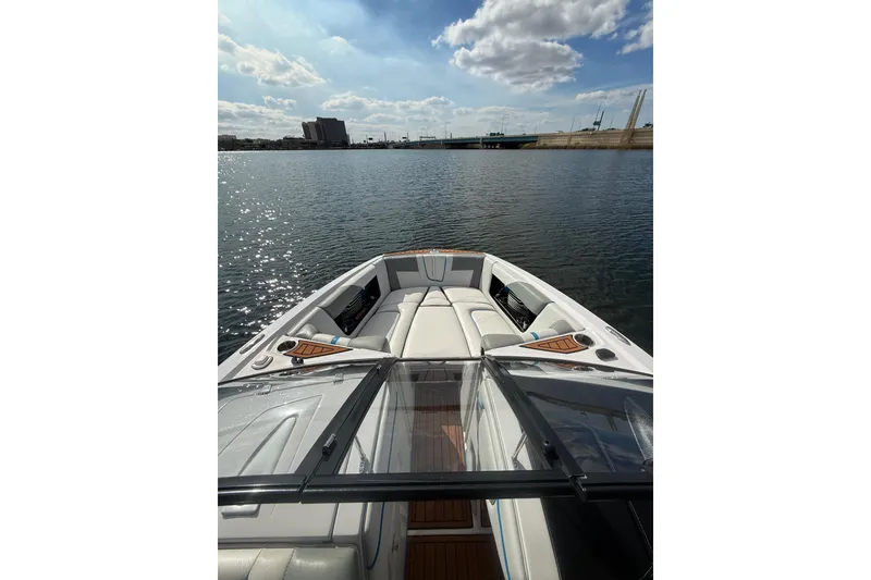 Slide: The Image of 2013 Nautique Super Air Nautique G23 Coastal Edition on calm water under a partly cloudy sky. - 5
