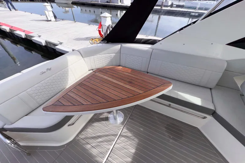 Slide: The Image of Luxurious seating area on 2022 Sea Ray Sundancer 320 yacht with wooden table. - 10