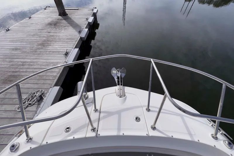 Slide: The Image of Bow view of 2022 Sea Ray Sundancer 320 docked at a marina. - 14