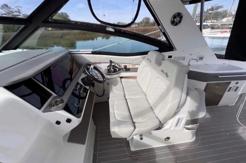 Slide: The Image of 2022 Sea Ray Sundancer 320 cockpit with modern helm, dual seats, and sleek design. - 15