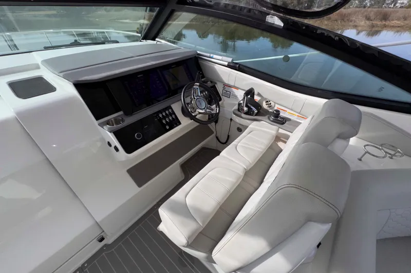 Slide: The Image of 2022 Sea Ray Sundancer 320 helm with modern controls and luxurious seating. - 16