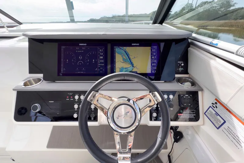Slide: The Image of 2022 Sea Ray Sundancer 320 helm with dual Simrad displays and modern controls. - 17