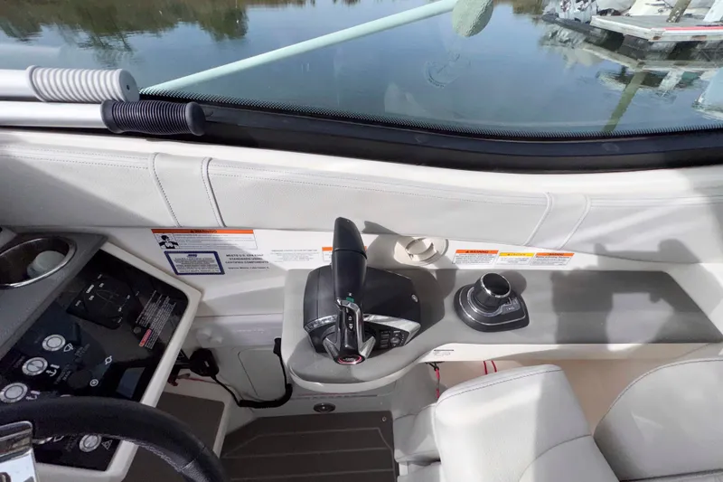 Slide: The Image of 2022 Sea Ray Sundancer 320 helm with controls and navigation equipment. - 18