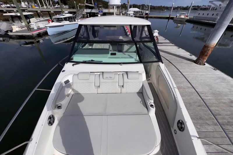 Slide: The Image of 2022 Sea Ray Sundancer 320 docked, showcasing spacious seating and sleek design. - 22