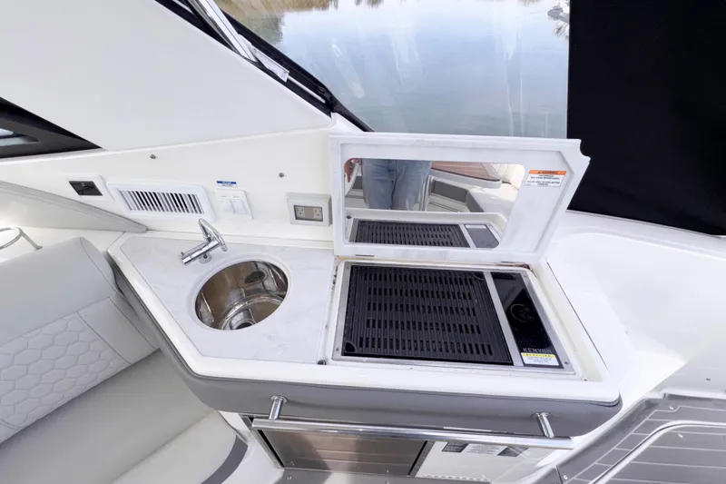 Slide: The Image of 2022 Sea Ray Sundancer 320 yacht kitchenette with sink and grill. - 23