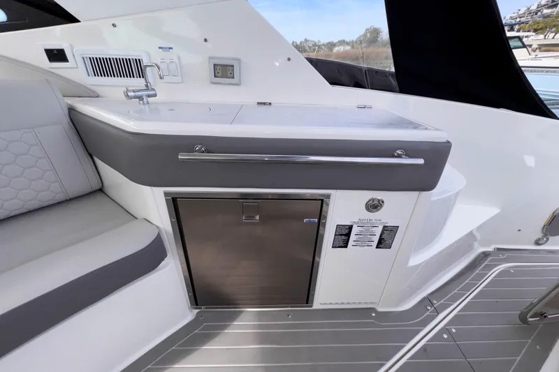 Slide: The Image of Luxurious 2022 Sea Ray Sundancer 320 yacht interior with sleek kitchenette and seating area. - 24