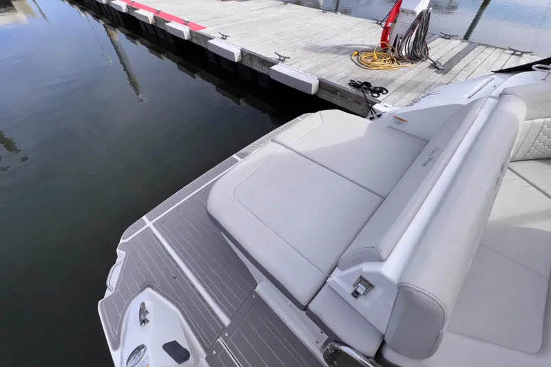 Slide: The Image of 2022 Sea Ray Sundancer 320 boat at dock, featuring spacious rear seating area. - 26