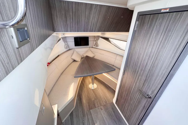 Slide: The Image of 2022 Sea Ray Sundancer 320 cabin interior with modern seating and table. - 30