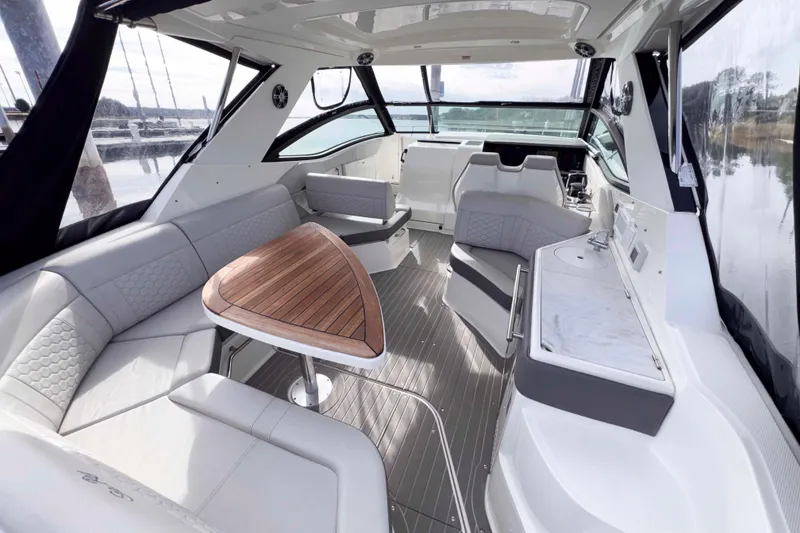 Slide: The Image of Luxurious interior of 2022 Sea Ray Sundancer 320 yacht with elegant seating and wooden table. - 6
