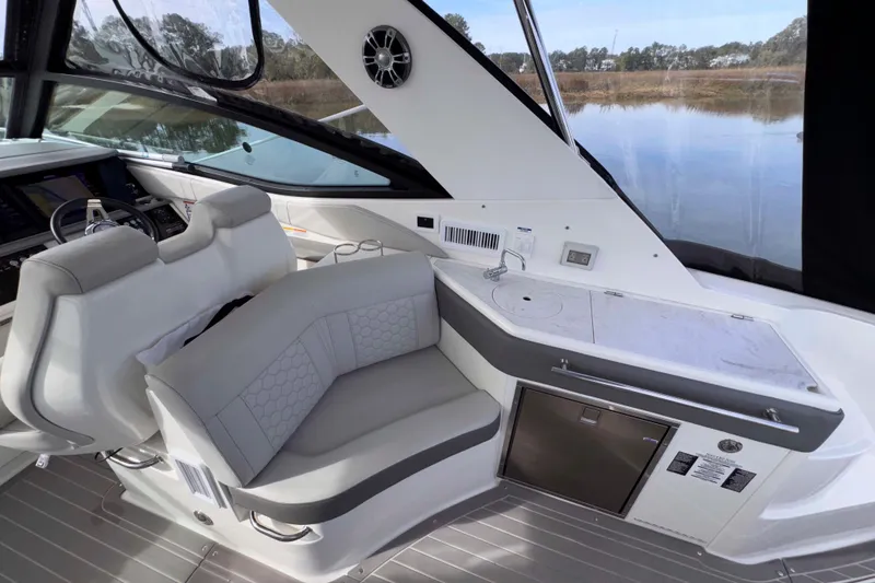Slide: The Image of Luxurious interior of 2022 Sea Ray Sundancer 320 yacht with seating and kitchenette. - 8