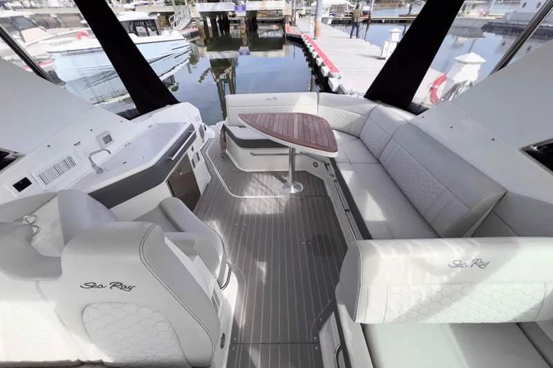 Slide: The Image of Luxurious 2022 Sea Ray Sundancer 320 yacht interior with elegant seating and wooden table. - 9