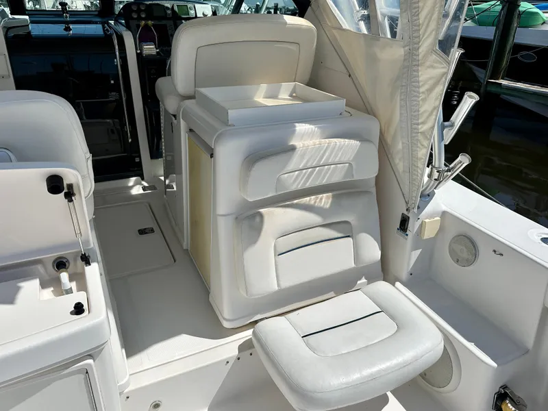 Slide: The Image of 2005 Tiara Yachts 3600 Open interior with white seating and helm area. - 13