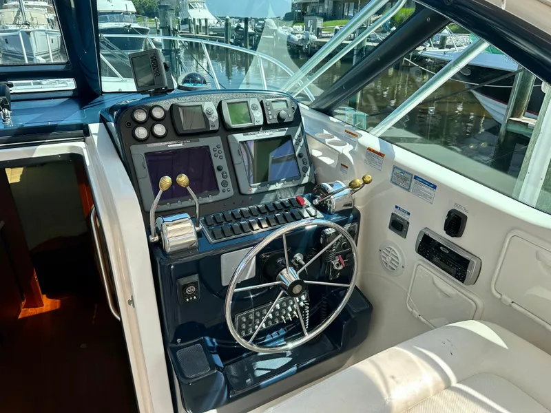 Slide: The Image of Helm of 2005 Tiara Yachts 3600 Open with navigation controls and steering wheel. - 18