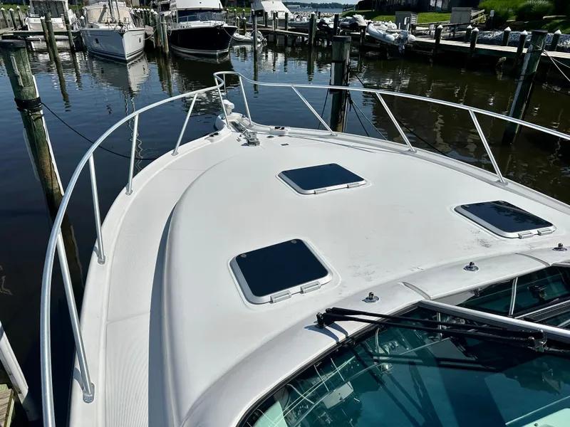 Slide: The Image of 2005 Tiara Yachts 3600 Open docked at marina, showcasing sleek deck design. - 19