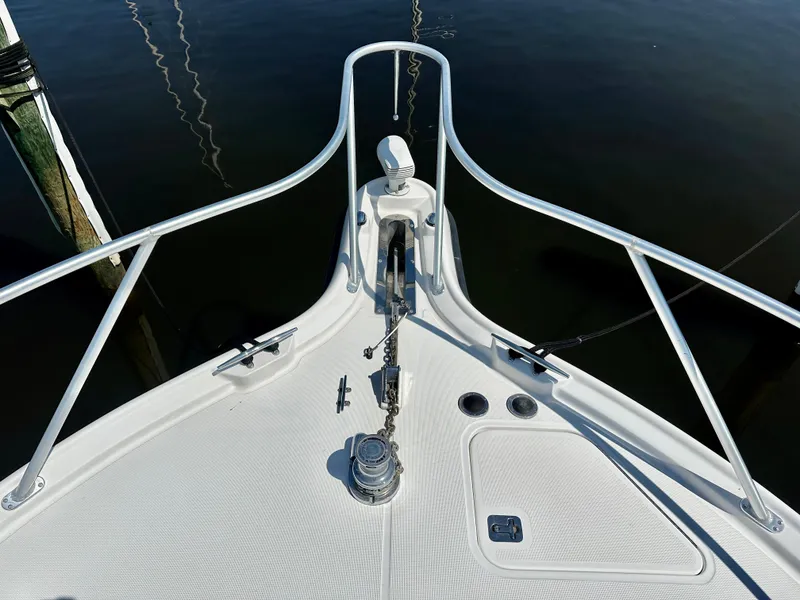 Slide: The Image of Bow of 2005 Tiara Yachts 3600 Open, featuring anchor and railing, docked on calm water. - 20