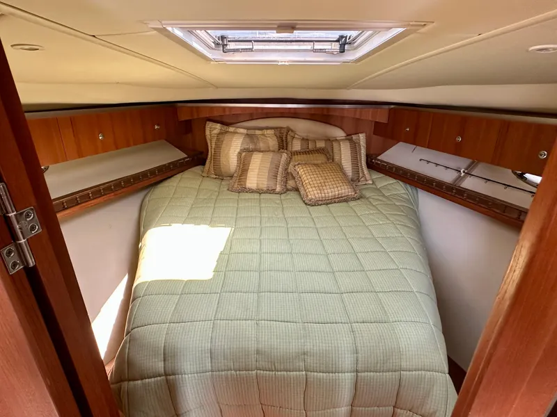 Slide: The Image of 2005 Tiara Yachts 3600 Open cabin with cozy bed and wooden cabinetry. - 22