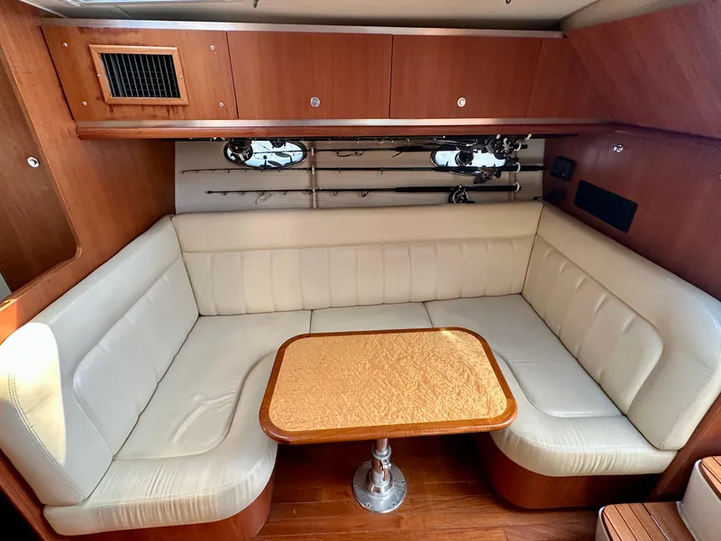 Slide: The Image of 2005 Tiara Yachts 3600 Open interior with cream seating and wooden table. - 23
