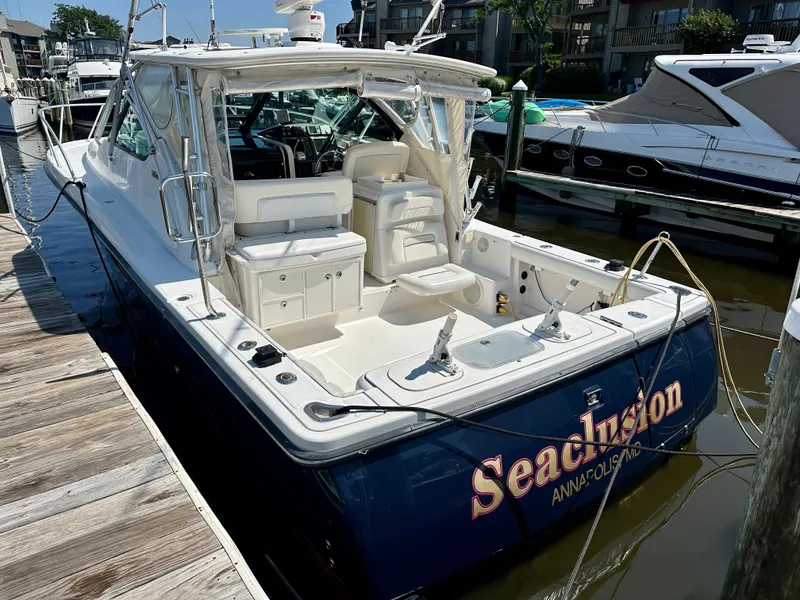 Slide: The Image of 2005 Tiara Yachts 3600 Open docked, featuring spacious seating and sleek design. - 6