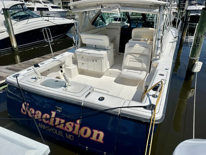 Slide: The Image of 2005 Tiara Yachts 3600 Open docked, featuring spacious seating and sleek design. - 7