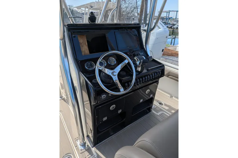 Slide: The Image of 2012 Blackwood 27 boat interior with rod holders and seating area. - 3