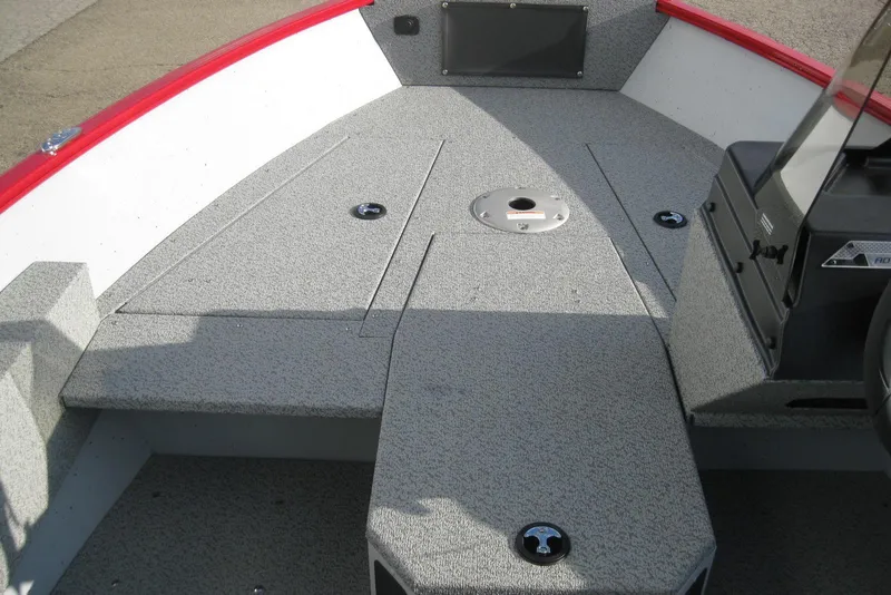 Slide: The Image of 2024 Lund 1775 Adventure SS boat dashboard with steering wheel and gauges. - 13