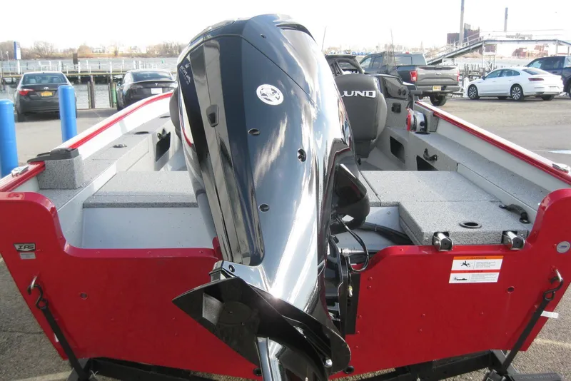 Slide: The Image of 2024 Lund 1775 Adventure SS boat with Mercury outboard motor, red exterior, and dual seats. - 5