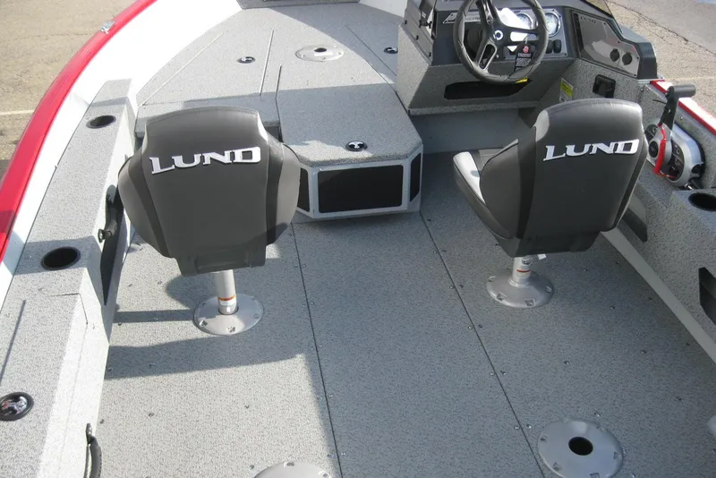 Slide: The Image of 2024 Lund 1775 Adventure SS boat with powerful outboard motor, docked at marina. - 6