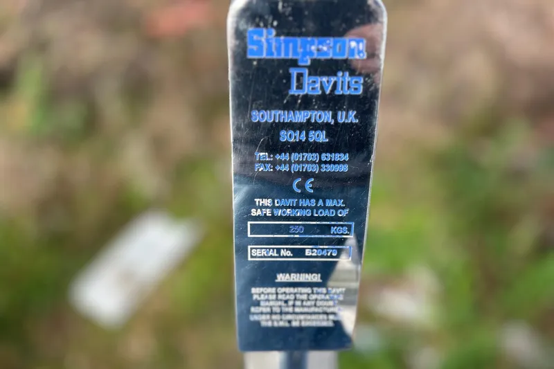 Slide: The Image of Simpson Davits label on Hanse 545, 2010 model, showing safe working load and contact details. - 12