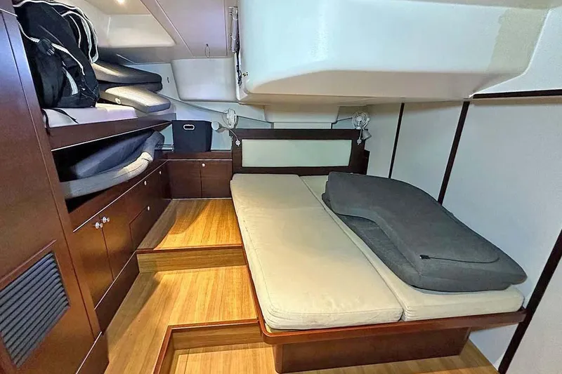 Slide: The Image of Interior cabin of 2010 Hanse 545 yacht with wooden flooring and cozy bedding. - 16