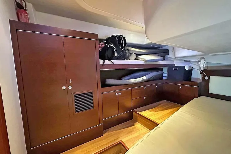 Slide: The Image of Interior of 2010 Hanse 545 yacht with wooden cabinetry and storage space. - 17