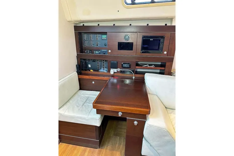 Slide: The Image of Interior of 2010 Hanse 545 yacht with navigation equipment and seating area. - 21