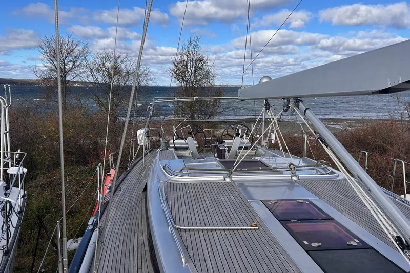 Slide: The Image of 2010 Hanse 545 sailboat onshore with ocean view and cloudy sky. - 4