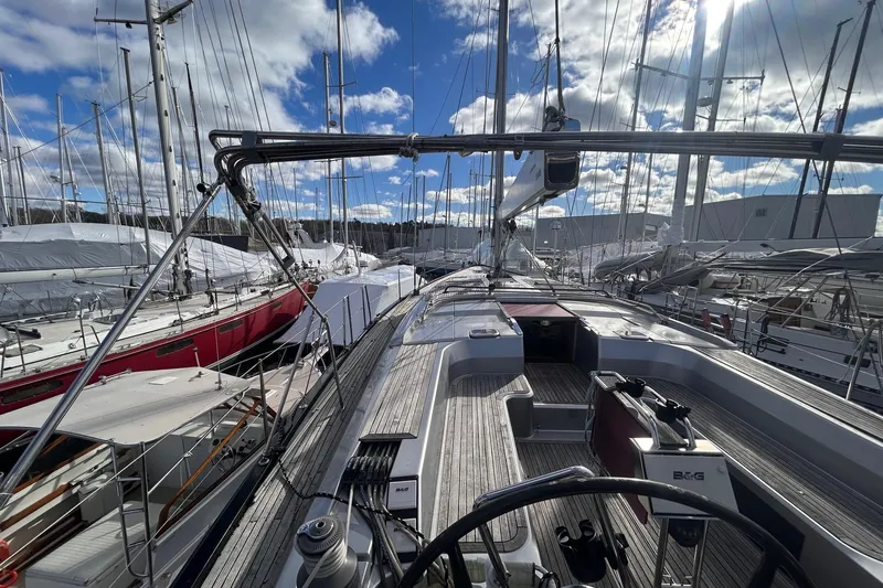 Slide: The Image of Sailing yacht Hanse 545, 2010 model, docked in a marina under a partly cloudy sky. - 6