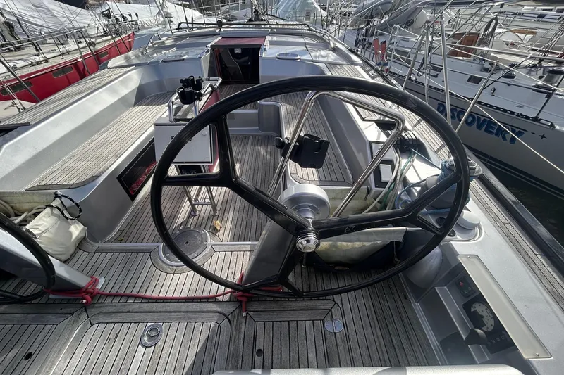 Slide: The Image of 2010 Hanse 545 yacht cockpit with large steering wheel and sleek design. - 8