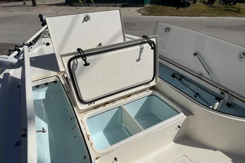 Slide: The Image of 2021 Sea Born FX24 Bay boat storage compartments open on deck. - 10