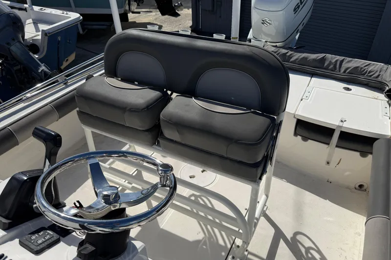 Slide: The Image of 2021 Sea Born FX24 Bay boat interior with dual seats and steering wheel. - 14