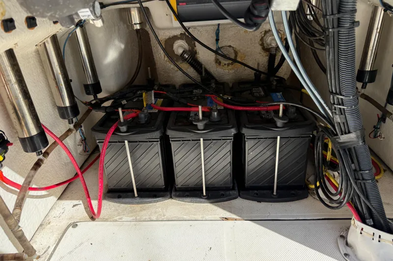 Slide: The Image of 2021 Sea Born FX24 Bay boat battery compartment with wiring and connections. - 16
